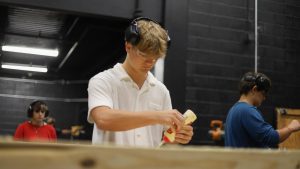 Putting a set piece together, Buxton Mathis (11) works in the new theatr scene shop.