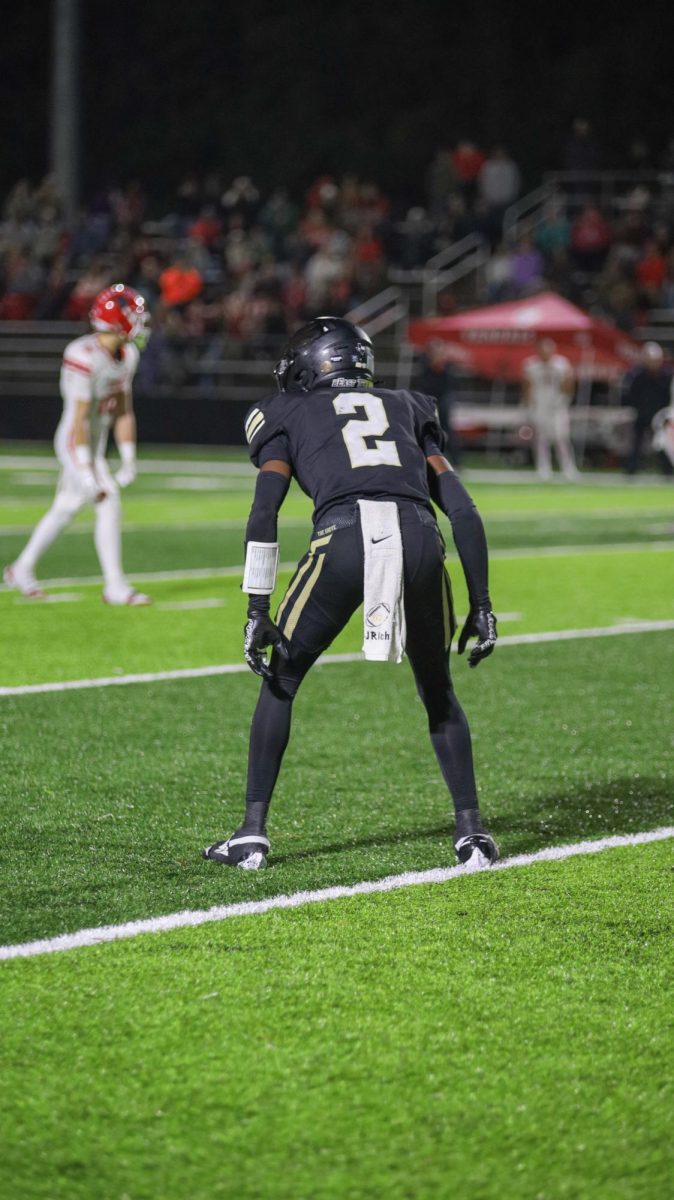 Lining up against the receiver, junior Jamarion Richardson gets ready to drop into coverage against the Van receiver.